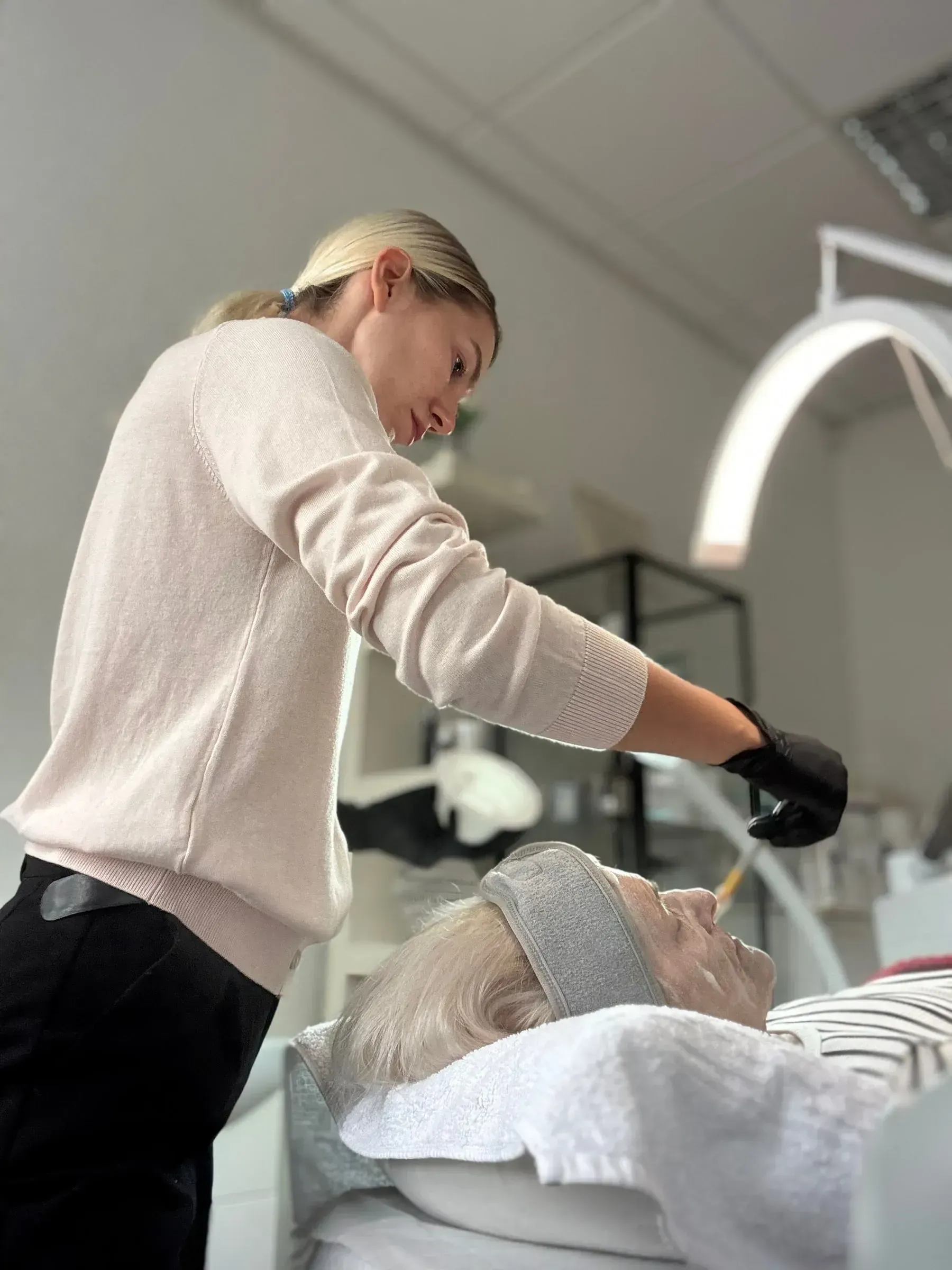 A specialist caring for a client during a treatment