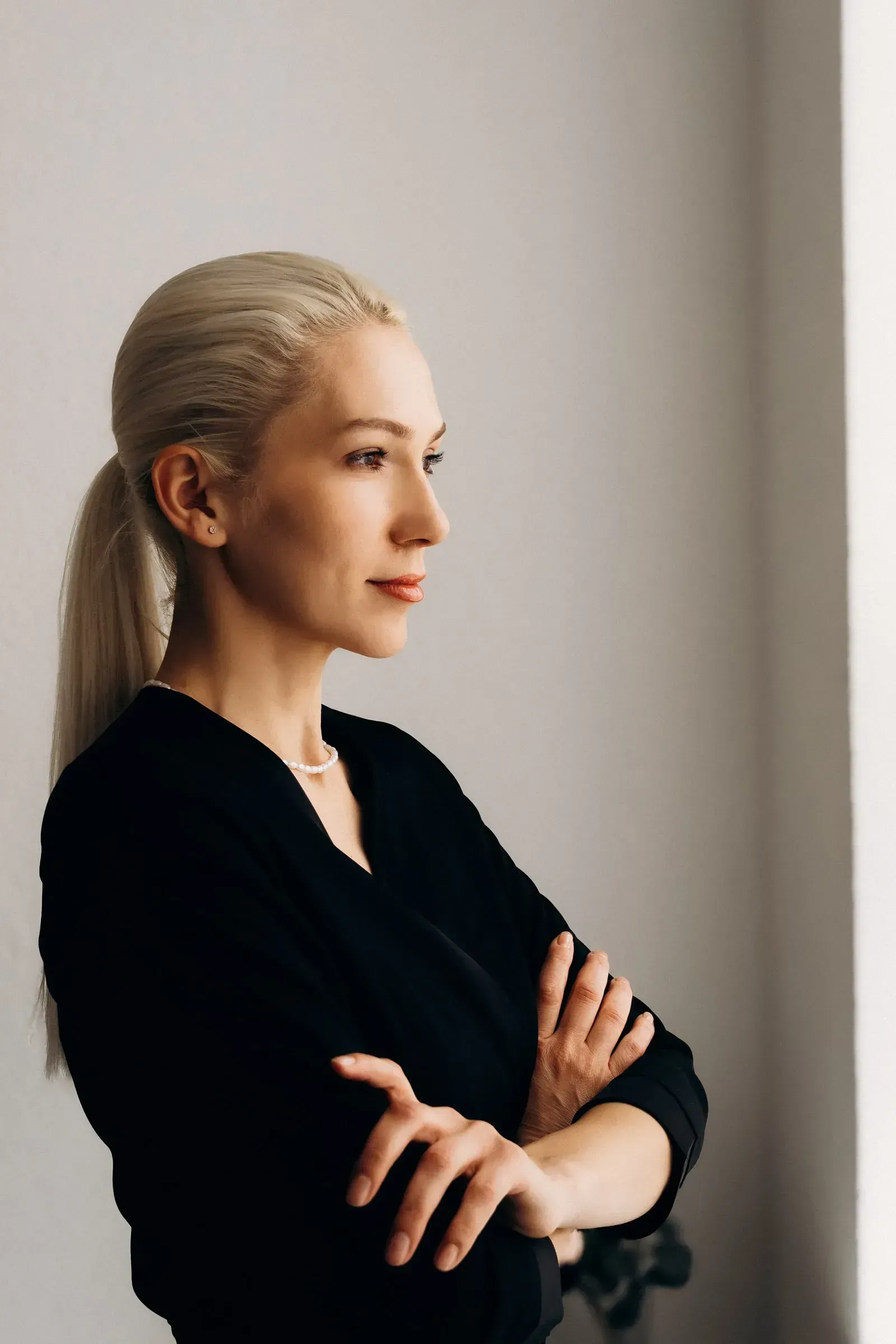 Ana, founder of Skin Care by Ana — a calm profile portrait in soft light