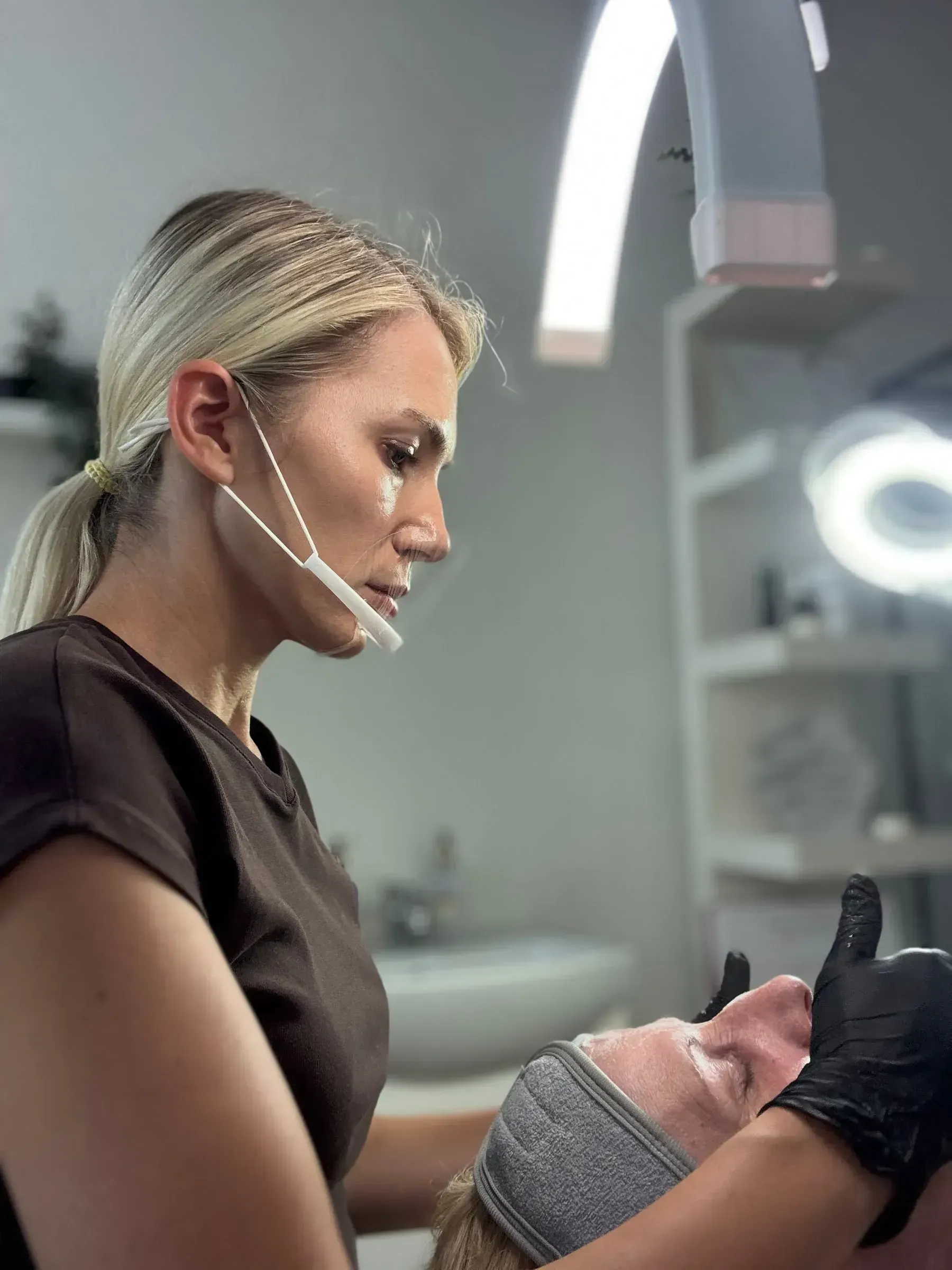 A specialist carrying out a facial treatment in the studio